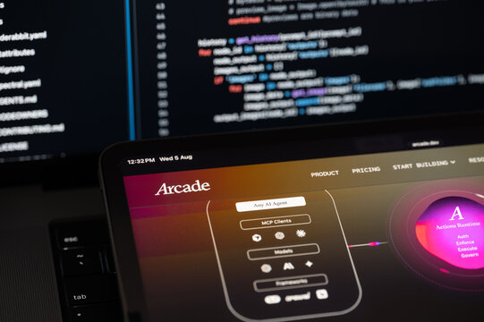 Arcade Dev Ai company web page on program code background