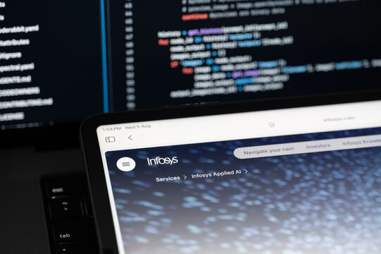 Infosys Ai company web page on program code background