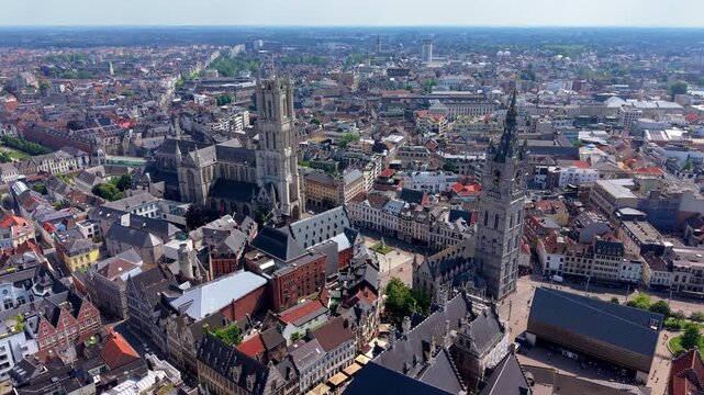 Aerial view video clip of historic Ghent cityscape, featuring Saint Bavo Cathedral, Belfry tower, city square, and traditional Flemish architecture in Belgium on a sunny day