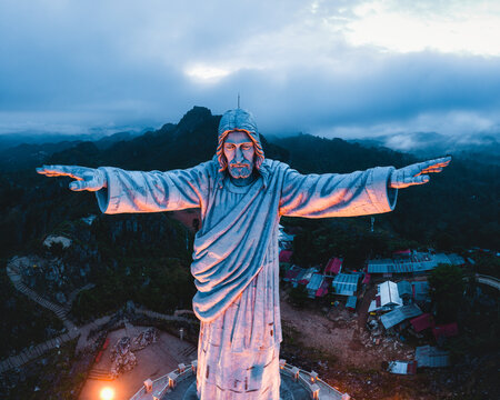 Aerial view of the Jesus Christ Blessing Statue standing prominently over the mountainous landscape of Makale, South Sulawesi, Indonesia.