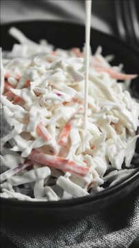 A delicious cole slaw salad served in a bowl, garnished and ready to eat.