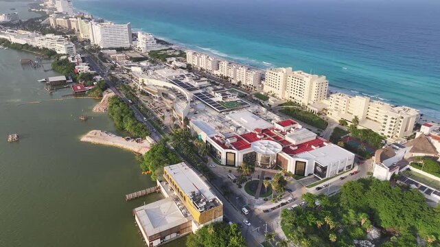 Aerial view of the hotel zone in Cancun with turquoise Caribbean sea, white sand beaches, and modern resorts along the coast in Cancun, Quintana Roo, Mexico.