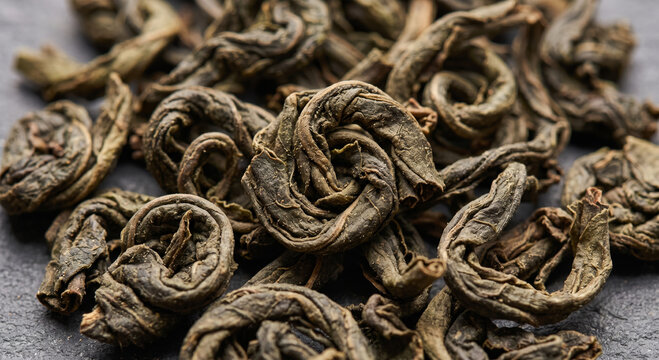 Macro close-up of rolled dried tea leaves showing natural curled texture