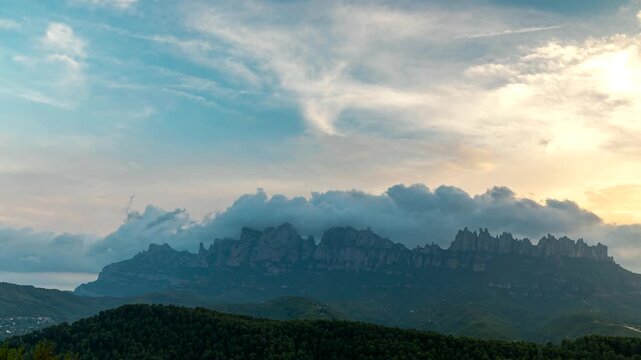 4K timelapse of sunset over Montserrat mountain range with rolling sea of clouds, Catalonia, Spain