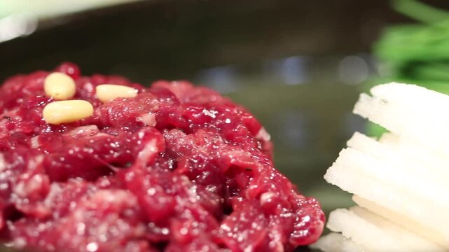 Korea raw beef yukhoe beef tartare seasoned raw beef with lotus root pine nuts sesame oil traditional korean food dish meal cuisine Korea 한국 소고기 육회 생고기 한우 연근 잣 참기름 양념육회 우둔살 한식 식재료 전통음식 대표요리