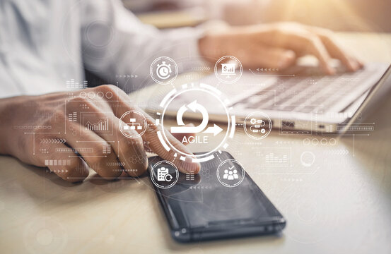 Close-Up of Hands Typing on Laptop with Smartphone, Digital Interface Representing Agile Methodology and Project Management Concepts. Entropy.