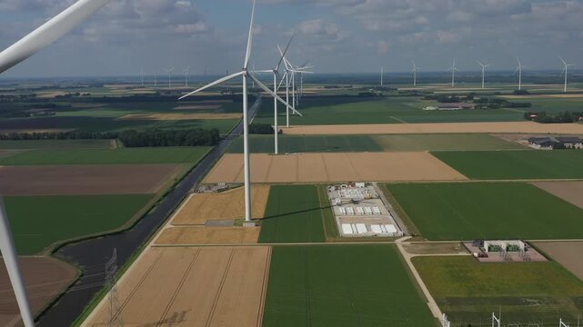 Aerial view of wind turbines and agricultural fields in the rural landscape of Dronten, Flevoland, Netherlands.