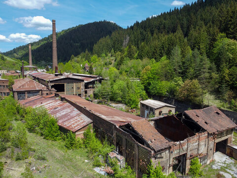 Abandoned industrial and smelting facilities, aerial drone view. Former industrial complex. Ruins of an abandoned metal smelting plant. Decaying industrial architecture of an old factory site.