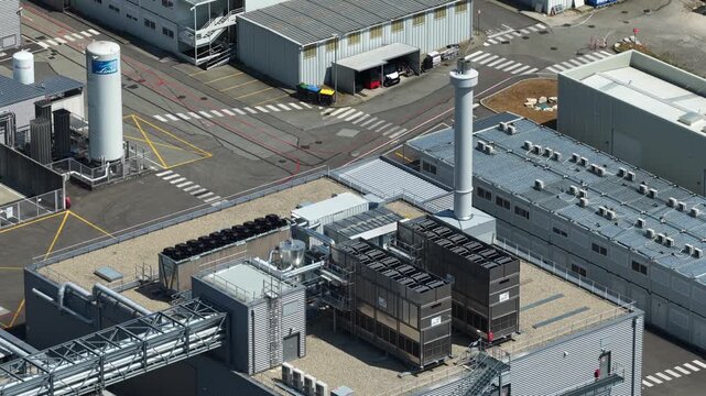 Bernin, Isere - France - August 1 2026: Aerial close-up of cooling towers, technical buildings and utility infrastructure at the Soitec semiconductor manufacturing facility