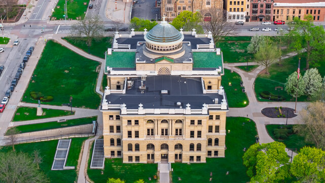Toledo, Ohio, United States - 10 July 2026: Aerial view of the Lucas County Courthouse featuring its prominent dome and green roof, surrounded by manicured lawns and urban streets.