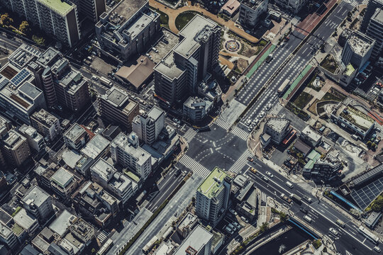 View of the dense urban landscape of Tokyo with intersecting roads, apartment buildings, and commercial structures in Tokyo, Tokyo, Japan.