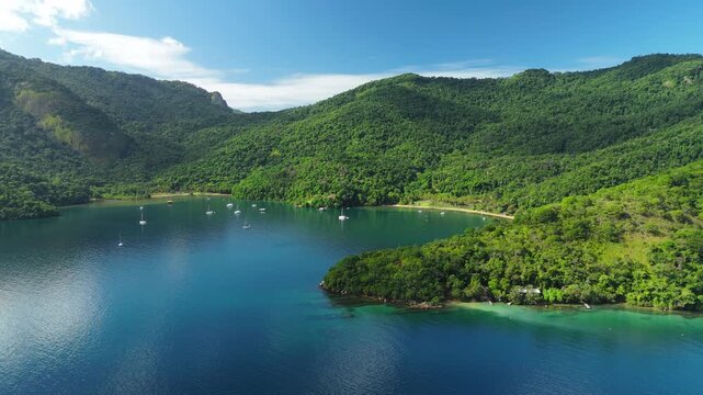 Aerial view of the calm and green lagoon with sailing boats on the island of Ilha Grande, Brazil