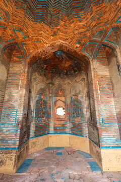 View of the intricate brickwork and blue glazed tile patterns inside a historic tomb at the Makli Necropolis in Thatta, Sindh, Pakistan.