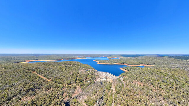 Worsley, Australia - 05 January 2026: Aerial view of Wellington Dam surrounded by dense eucalyptus forests and the blue waters of the reservoir.