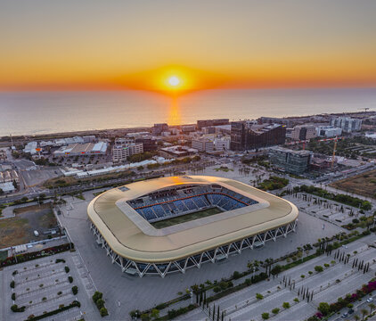 Aerial view of Sammy Ofer Stadium at sunset with the Mediterranean Sea in the background in Haifa, Haifa District, Israel.