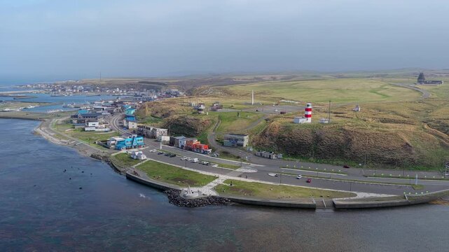 Aerial view of the iconic Cape Soya lighthouse and surrounding coastal landscape in Wakkanai, Hokkaido, Japan.