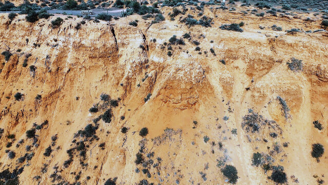 Aerial view of the Matthew Flinders Red Cliff Lookout featuring dramatic red sandstone cliffs and sparse desert vegetation in Port Augusta West, South Australia, Australia.