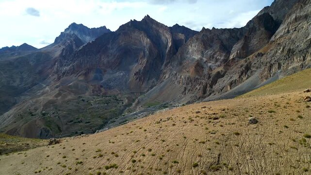 Aerial view of the rugged Zanskar valley with winding dirt roads and dramatic mountain peaks in Zanskar, Ladakh, India.