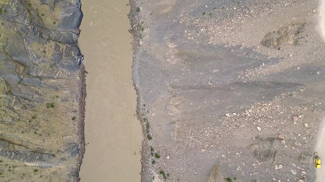 Aerial view of the Zanskar River flowing through the arid and rugged mountainous landscape of Zanskar, Ladakh, India.