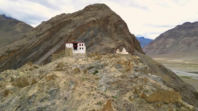 Aerial view of Zanskar Monastery perched on a rocky ridge with stupas and rugged mountain terrain in Zanskar, Ladakh, India.