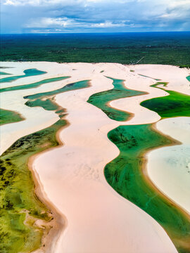 Aerial view of Lagoa Bonita featuring white sand dunes and turquoise lagoons in Barreirinhas, State of Maranhao, Brazil.