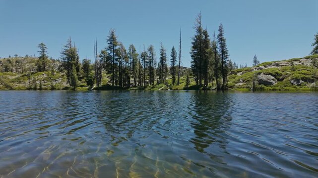 Loch Leven Lake framed by pine trees and granite shores in California