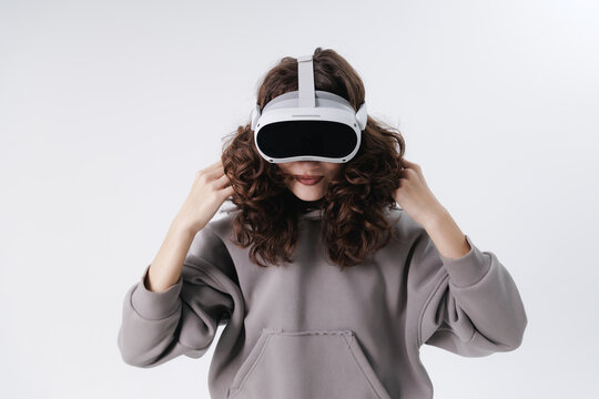 Young asian female wearing vr headset adjusting hair