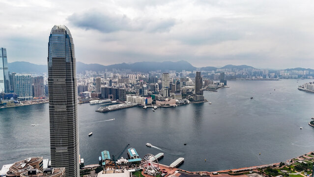 Hong Kong, Hong Kong - 12 July 2026: Aerial view of the skyline featuring Two International Finance Centre, the Hong Kong Observation Wheel, and Victoria Harbour under a cloudy sky.