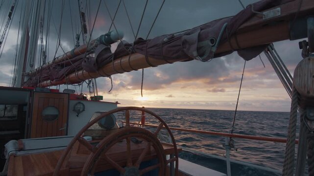 Expeditional sailing vessel moves in the Atlantic Ocean during sunrise