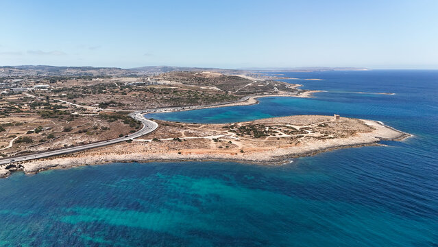 Aerial view of Naxxar coastal road by Malta's Mediterranean shoreline.