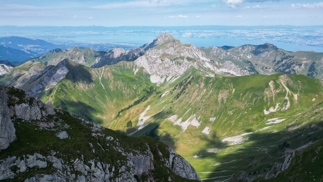 Aerial view of Cornettes de Bise mountain peak surrounded by lush green alpine slopes and rocky ridges, La Chapelle-d'Abondance, Auvergne-Rhone-Alpes, France.
