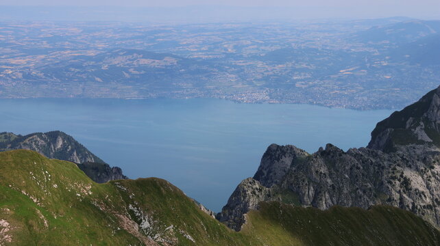 View of Cornettes de Bise overlooking the vast expanse of Lake Geneva with lush green mountain slopes and rocky peaks, La Chapelle-d'Abondance, Auvergne-Rhone-Alpes, France.