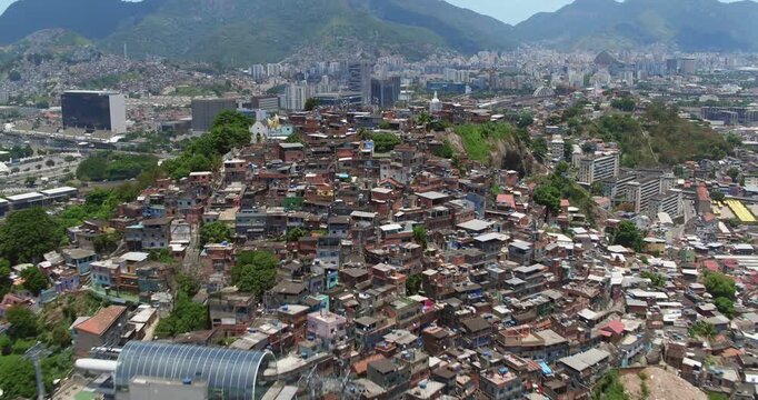 Aerial view of a dense favela community built on a hillside with colorful houses and narrow streets in Rio de Janeiro, State of Rio de Janeiro, Brazil.
