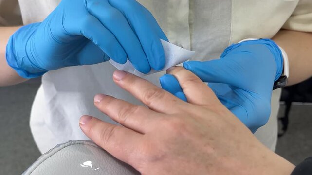 A lint free wipe gently removes the remaining coating to prepare natural nails for the next manicure step. Clean nail preparation supports a neat finish and healthy nail care.