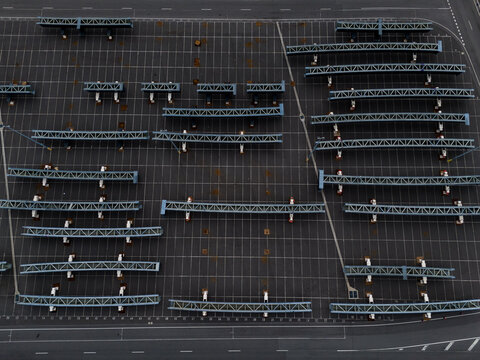 Port Melbourne, Australia - 01 April 2026: Aerial view of the Port Melbourne parking area with rows of metal structures and marked parking bays.