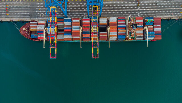 Aerial view of the container ship docked at MPS Terminal 3 with colorful shipping containers and gantry cranes at the port in Accra, Greater Accra, Ghana.