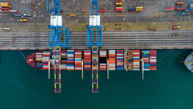 Aerial view of a large container ship being unloaded by gantry cranes at MPS Terminal 3 in the port of Accra, Greater Accra, Ghana.