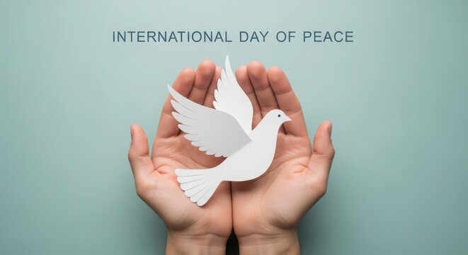 International day of peace, hands holding a paper dove, symbol of peace and harmony