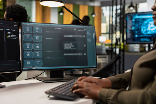 Close-up of a software developer using an AI chatbot shows prompt-based problem solving with predictive technology and interaction with a large language model program on an office computer.