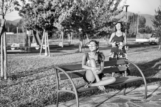 Artistic black and white view of solar eclipse with family in park