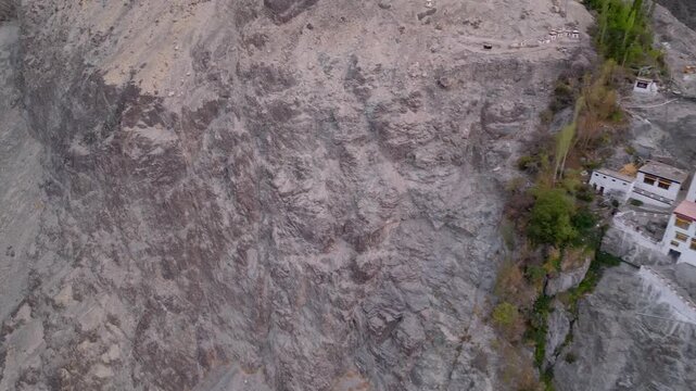 Aerial view of the rugged rocky cliff face near Diskit Monastery in the arid mountain landscape of Diskit, Ladakh, India.