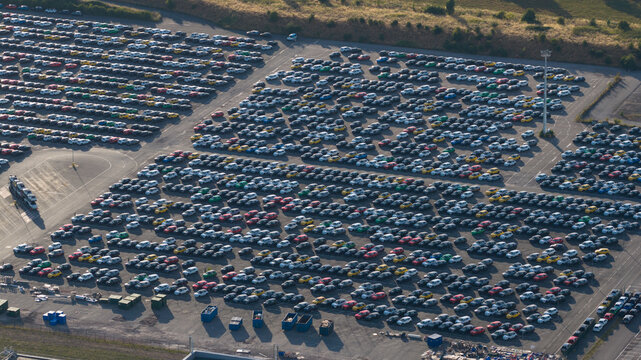 Aerial view of the Renault Douai factory parking lot filled with rows of new cars, showcasing the vast storage area in Lambres-lez-Douai, Hauts-de-France, France.