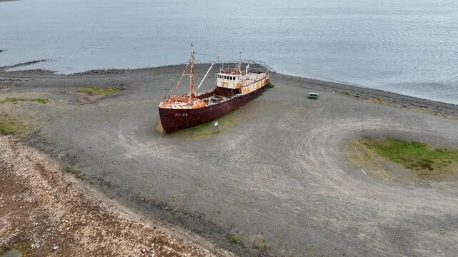 Aerial view of the historic Gardar BA 64 shipwreck resting on the rocky beach in Saudlauksdalur, Vesturbyggd, Iceland.