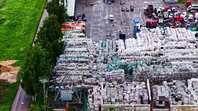 Aerial view of a large recycling facility with stacks of baled materials and vehicles parked in the yard in Jelgava, Jelgava pilseta, Latvia.