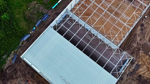 Aerial view of the ongoing construction of the Jelgava Palace structure showing the steel framework and metal roofing panels in Jelgava, Jelgava, Latvia.