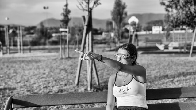 Black and white portrait of girl observing solar eclipse in public park