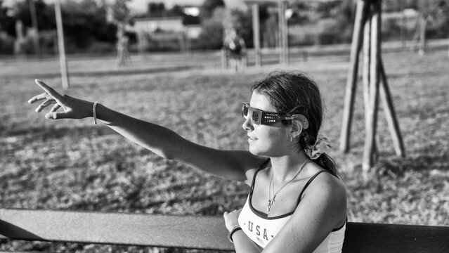Girl witnessing solar eclipse in park with timeless black and white style