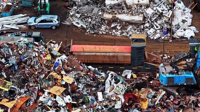 Aerial view of scrap metal yard with heavy machinery and piles of recycled materials in Jelgava, Jelgava pilseta, Latvia.