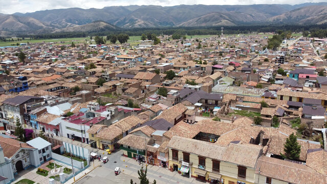 Aerial view of the historic town of Jauja, featuring traditional clay-tiled rooftops, narrow streets, and the surrounding Andean mountains in Jauja, Junin, Peru.