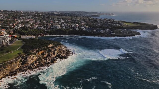 Aerial view of Gordons Bay with rocky cliffs and coastal residential area in Coogee, New South Wales, Australia.